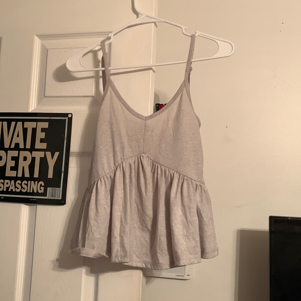 A grey tank top made by Poof New York in a size Small with a flowy bottom